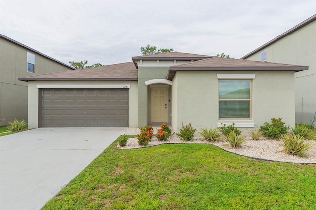 view of front of home with a front yard and a garage