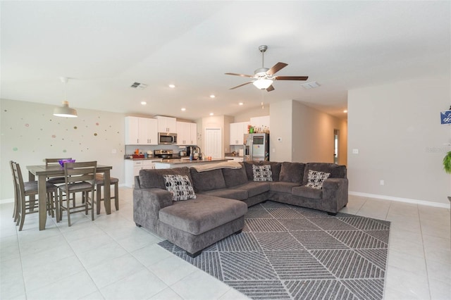 living room with vaulted ceiling, sink, and ceiling fan