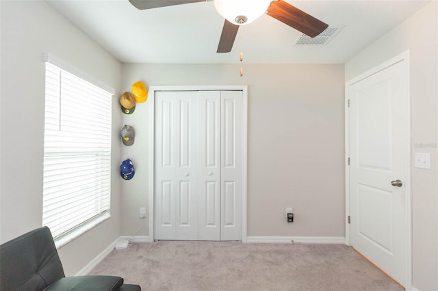 unfurnished room with light carpet and ceiling fan