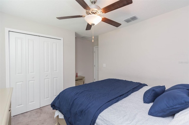 carpeted bedroom with a closet and ceiling fan