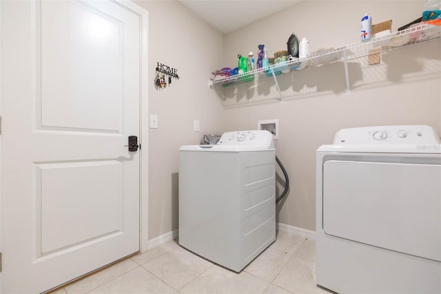 laundry room with light tile patterned floors and independent washer and dryer