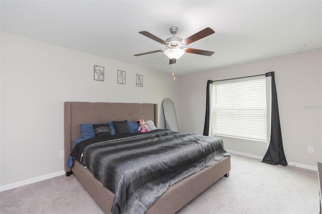 bedroom with ceiling fan and light colored carpet