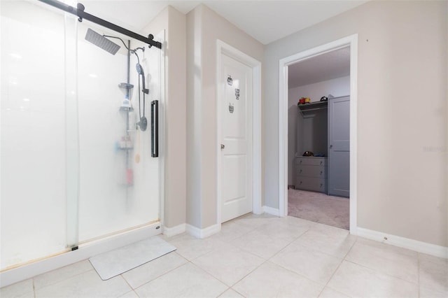 bathroom featuring tile patterned flooring and an enclosed shower