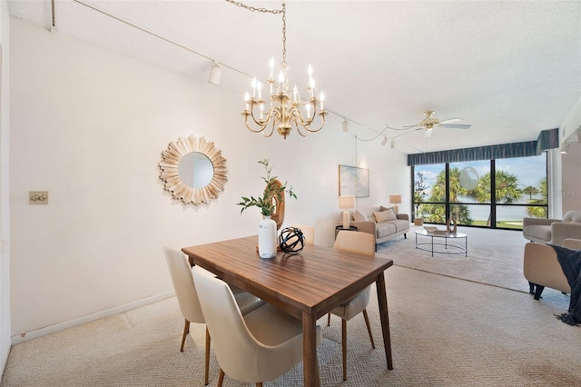 carpeted dining space with ceiling fan with notable chandelier and a textured ceiling