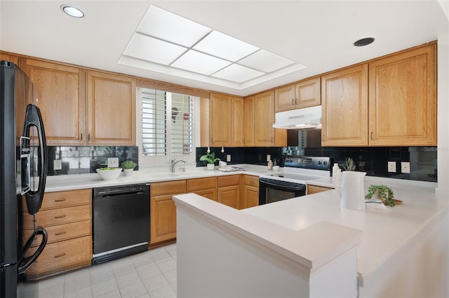 kitchen featuring backsplash, light tile patterned floors, black appliances, kitchen peninsula, and sink