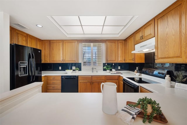 kitchen featuring black appliances, sink, and decorative backsplash