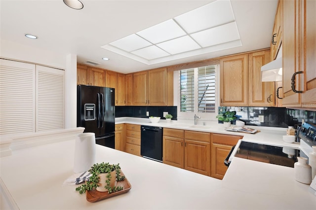 kitchen with tasteful backsplash, black appliances, kitchen peninsula, sink, and extractor fan