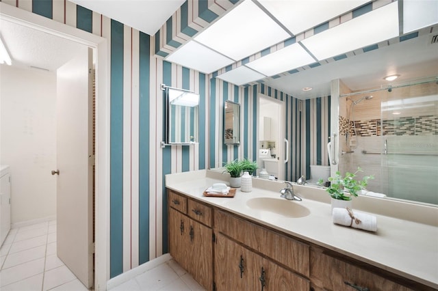 bathroom with vanity, an enclosed shower, and tile patterned flooring