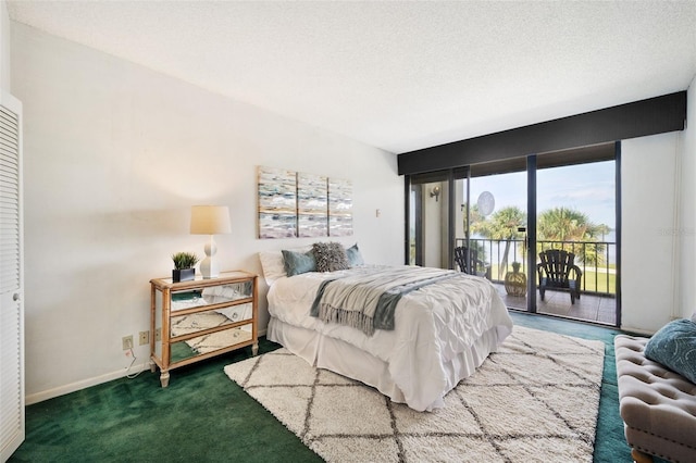 carpeted bedroom featuring access to outside and a textured ceiling