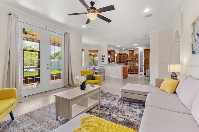 living room with ornamental molding, ceiling fan, light tile patterned floors, and french doors