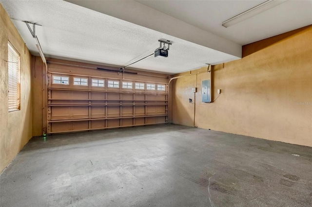 garage featuring electric panel and a garage door opener