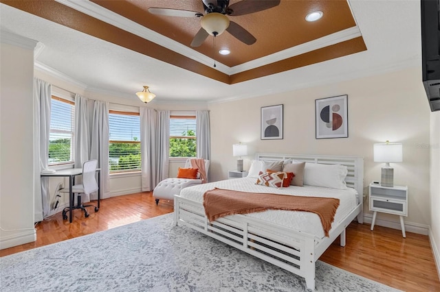 bedroom with ceiling fan, ornamental molding, and hardwood / wood-style floors