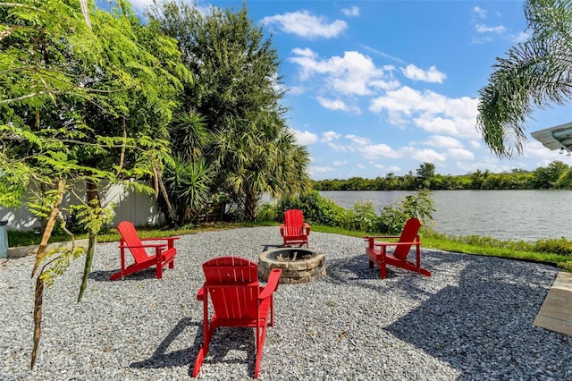 view of yard with a water view and an outdoor fire pit