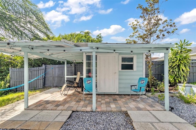 view of patio featuring a shed