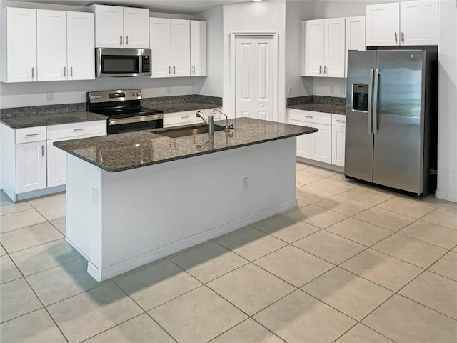 kitchen featuring sink, appliances with stainless steel finishes, white cabinets, and a kitchen island with sink