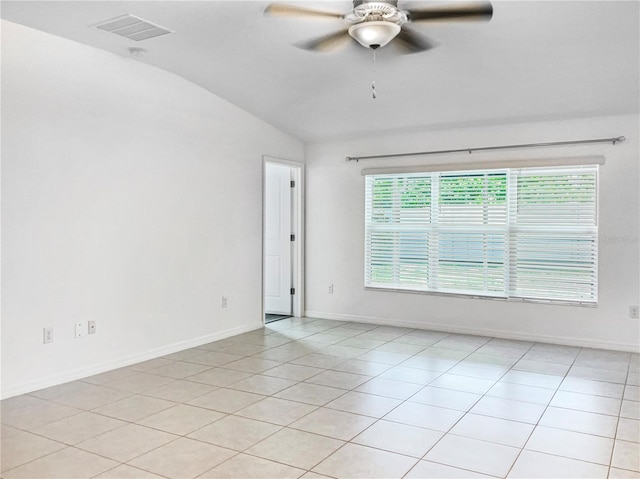 spare room featuring light tile patterned floors, visible vents, a ceiling fan, and lofted ceiling