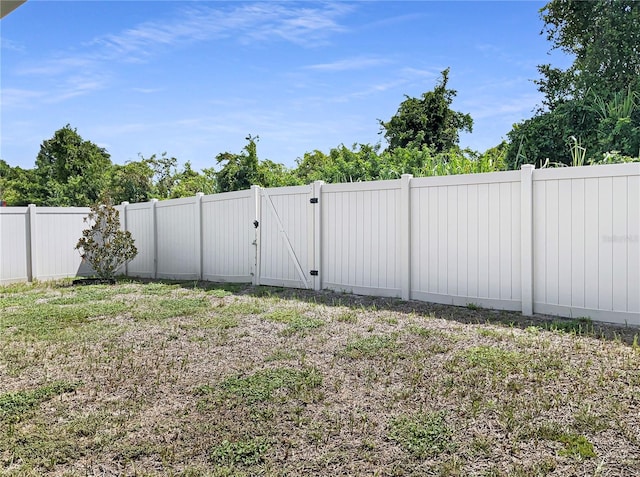 view of yard featuring a gate and a fenced backyard