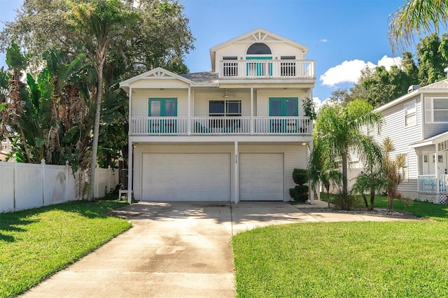 view of front of property with a balcony, a garage, and a front yard