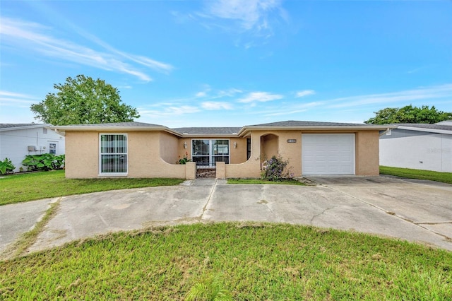 ranch-style home featuring stucco siding, an attached garage, concrete driveway, and a front yard