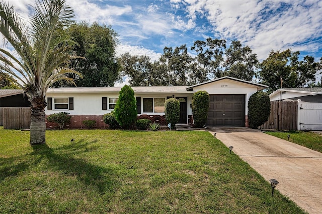 ranch-style home featuring a garage and a front lawn