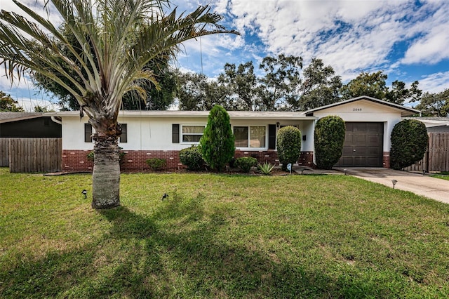 ranch-style home featuring a garage and a front lawn