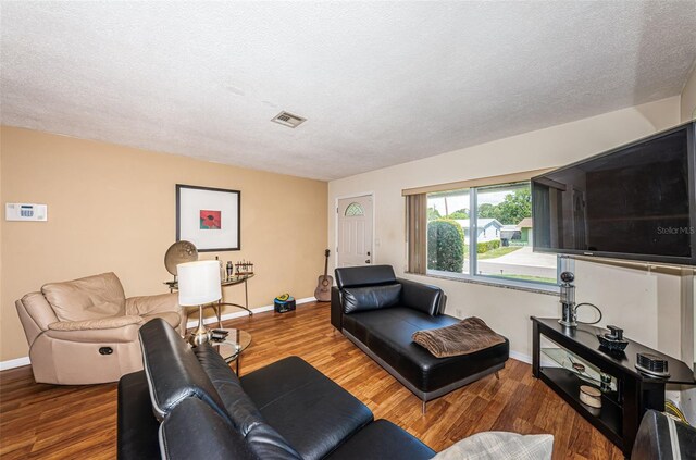 living room featuring hardwood / wood-style flooring and a textured ceiling