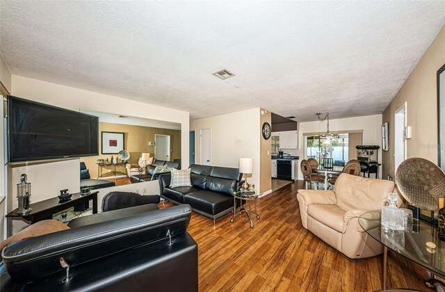 living room featuring wood-type flooring and a textured ceiling