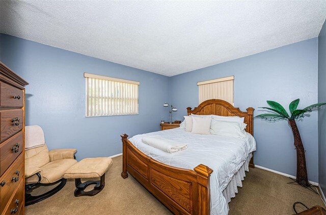 carpeted bedroom featuring a textured ceiling