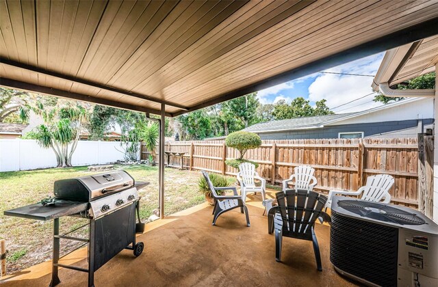 view of patio with a fire pit, a grill, and central air condition unit