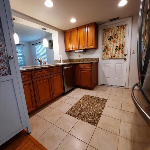 kitchen with sink, stainless steel appliances, light tile patterned floors, and pendant lighting