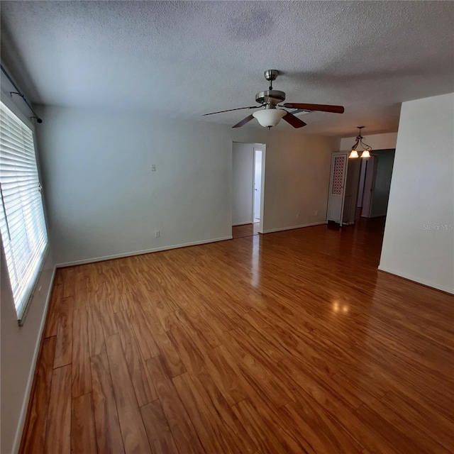 spare room featuring a textured ceiling, hardwood / wood-style flooring, and ceiling fan