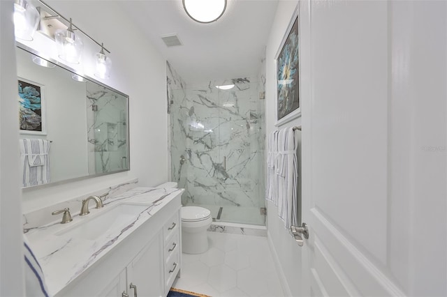 bathroom with tile patterned floors, toilet, an enclosed shower, and vanity