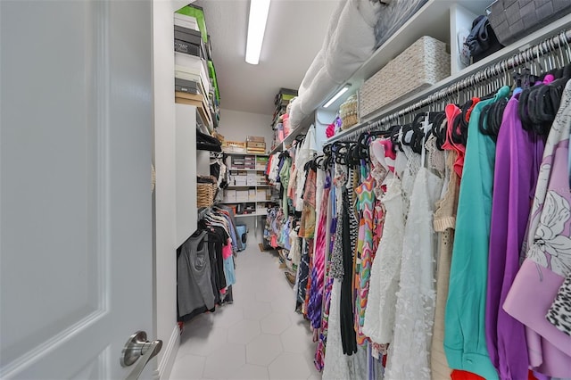 walk in closet with light tile patterned floors