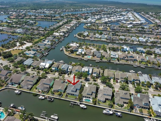 drone / aerial view featuring a residential view and a water view