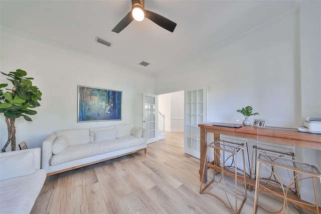 living room featuring a ceiling fan, french doors, visible vents, and wood finished floors