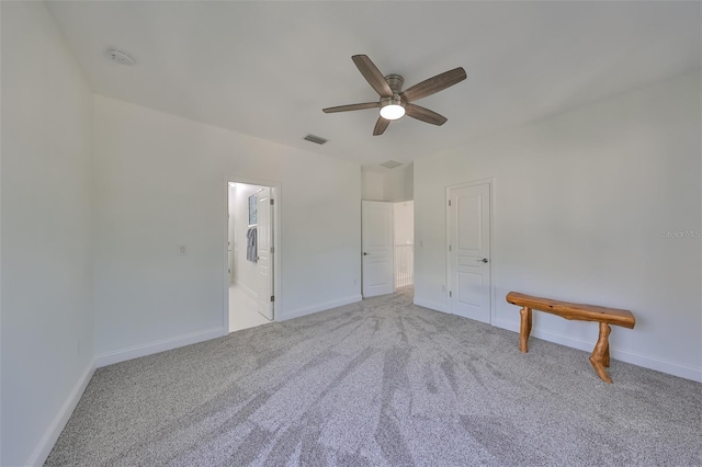 unfurnished bedroom with carpet floors, baseboards, visible vents, and ceiling fan