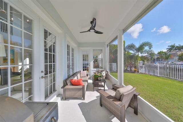 sunroom / solarium with a ceiling fan