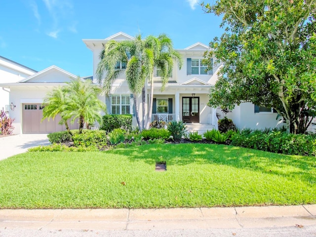 view of front facade featuring a front lawn and a garage