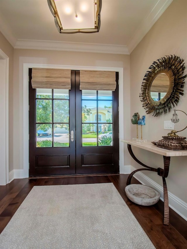 doorway with ornamental molding, dark hardwood / wood-style flooring, and french doors