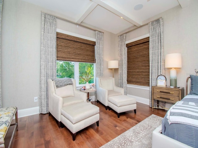 bedroom with hardwood / wood-style floors and beamed ceiling