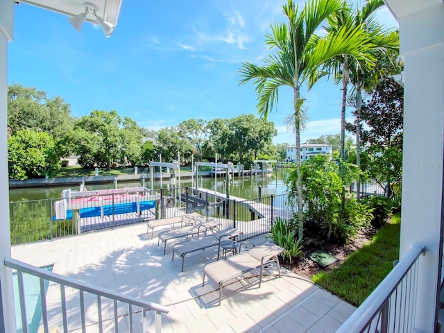 surrounding community featuring a water view and a patio