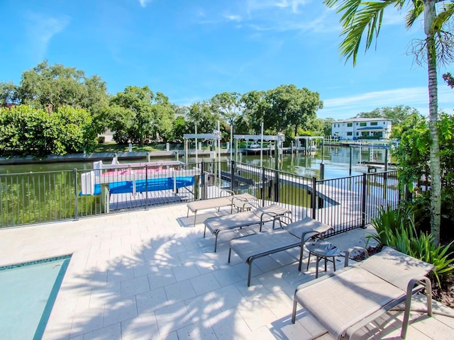 view of patio / terrace with a water view and a boat dock