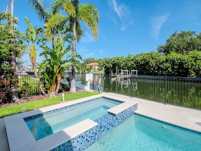 view of pool with a water view and an in ground hot tub