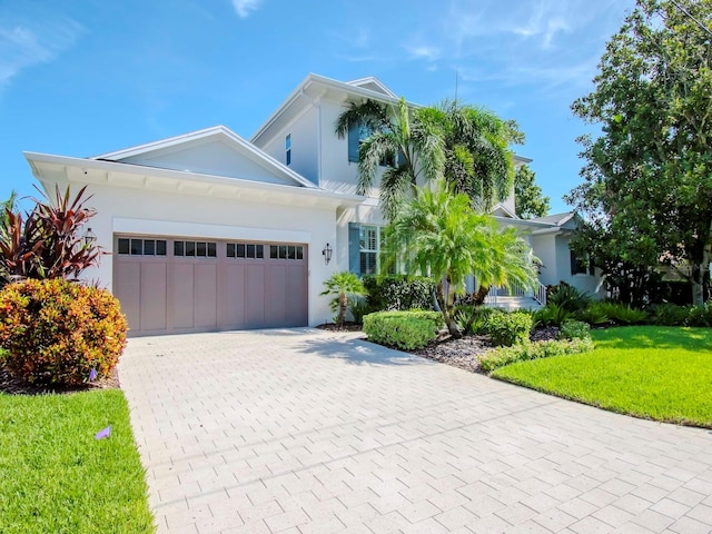 view of front facade featuring a front yard and a garage