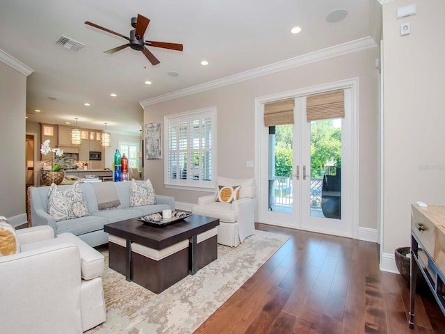 living room featuring dark wood-type flooring, ceiling fan, crown molding, and french doors