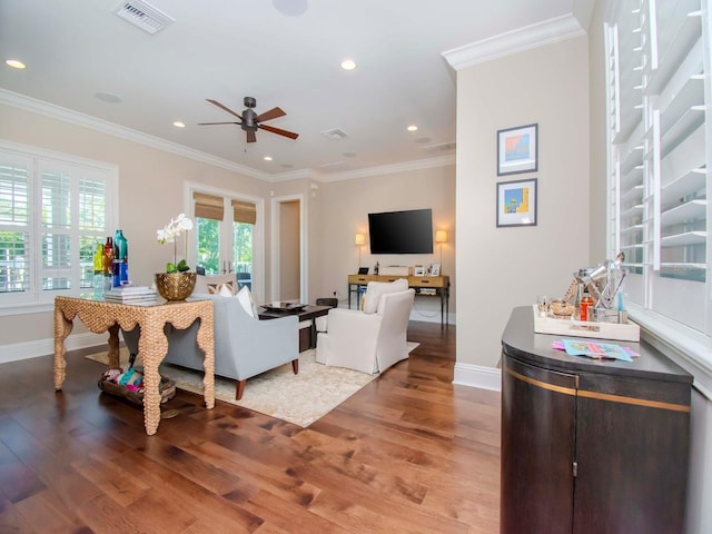 living room featuring ceiling fan, ornamental molding, and hardwood / wood-style flooring