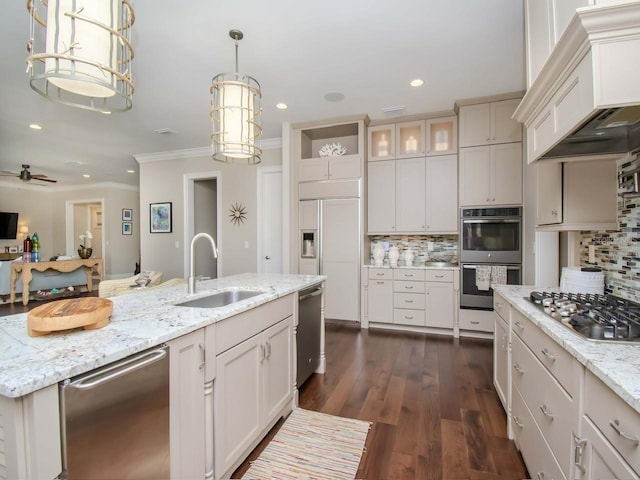 kitchen featuring backsplash, custom exhaust hood, sink, appliances with stainless steel finishes, and light stone counters