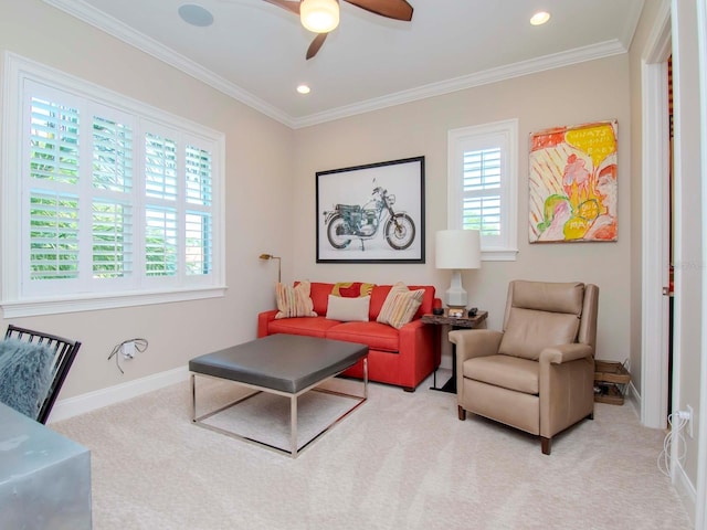 living room featuring ceiling fan, light colored carpet, plenty of natural light, and crown molding