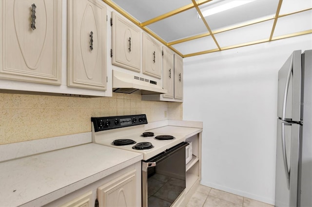 kitchen with backsplash, stainless steel fridge, white electric range oven, and light tile patterned flooring