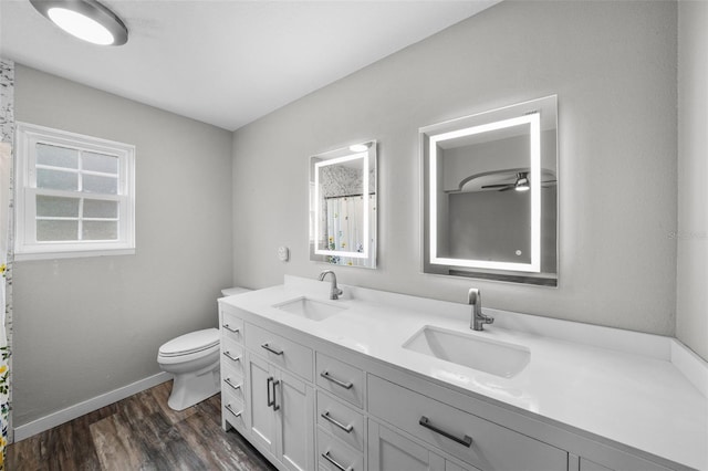 bathroom featuring toilet, vanity, and hardwood / wood-style flooring